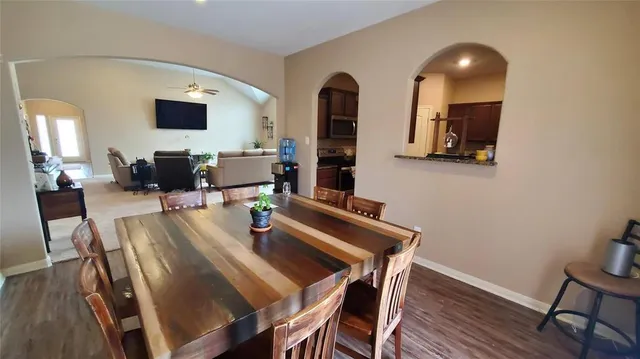 a view of a dining room with furniture and wooden floor
