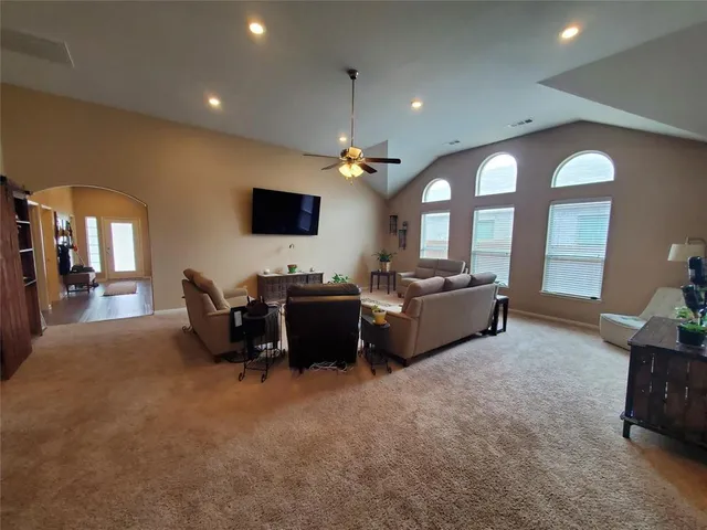 a living room with furniture and a flat screen tv