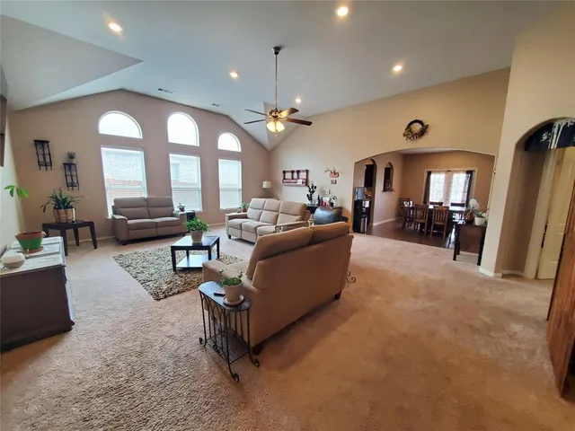 a living room with furniture and a chandelier