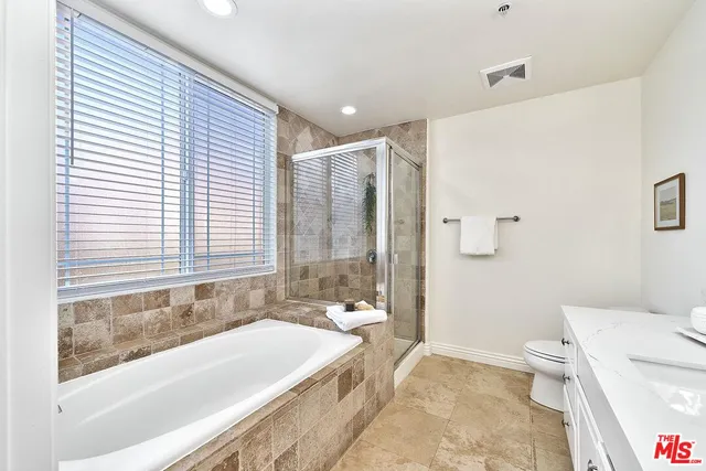 a spacious bathroom with a bathtub and toilet