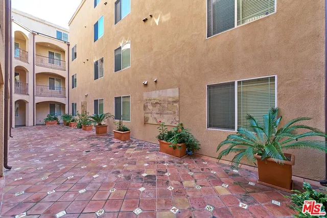 a view of a building with potted plants