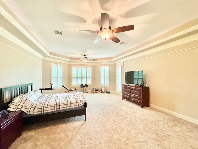 a bedroom with furniture and a flat screen tv