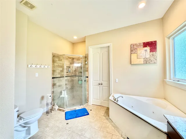 a bathroom with a tub and a shower
