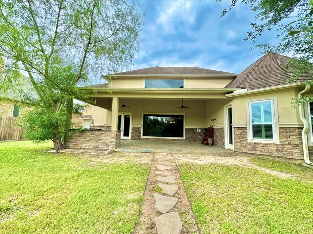 a view of a house with a yard and sitting area