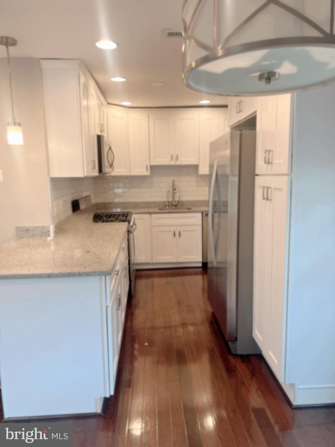 2006 Griffith Road Falls Church, VA 22043 - Photo 3 of 17 a kitchen with stainless steel appliances granite countertop a sink stove and refrigerator