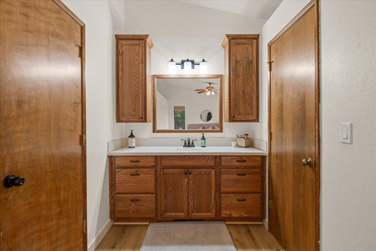 350 Splendor Drive Wilderville, OR 97543 - Photo 23 of 57 a bathroom with a granite countertop sink a mirror and a shower