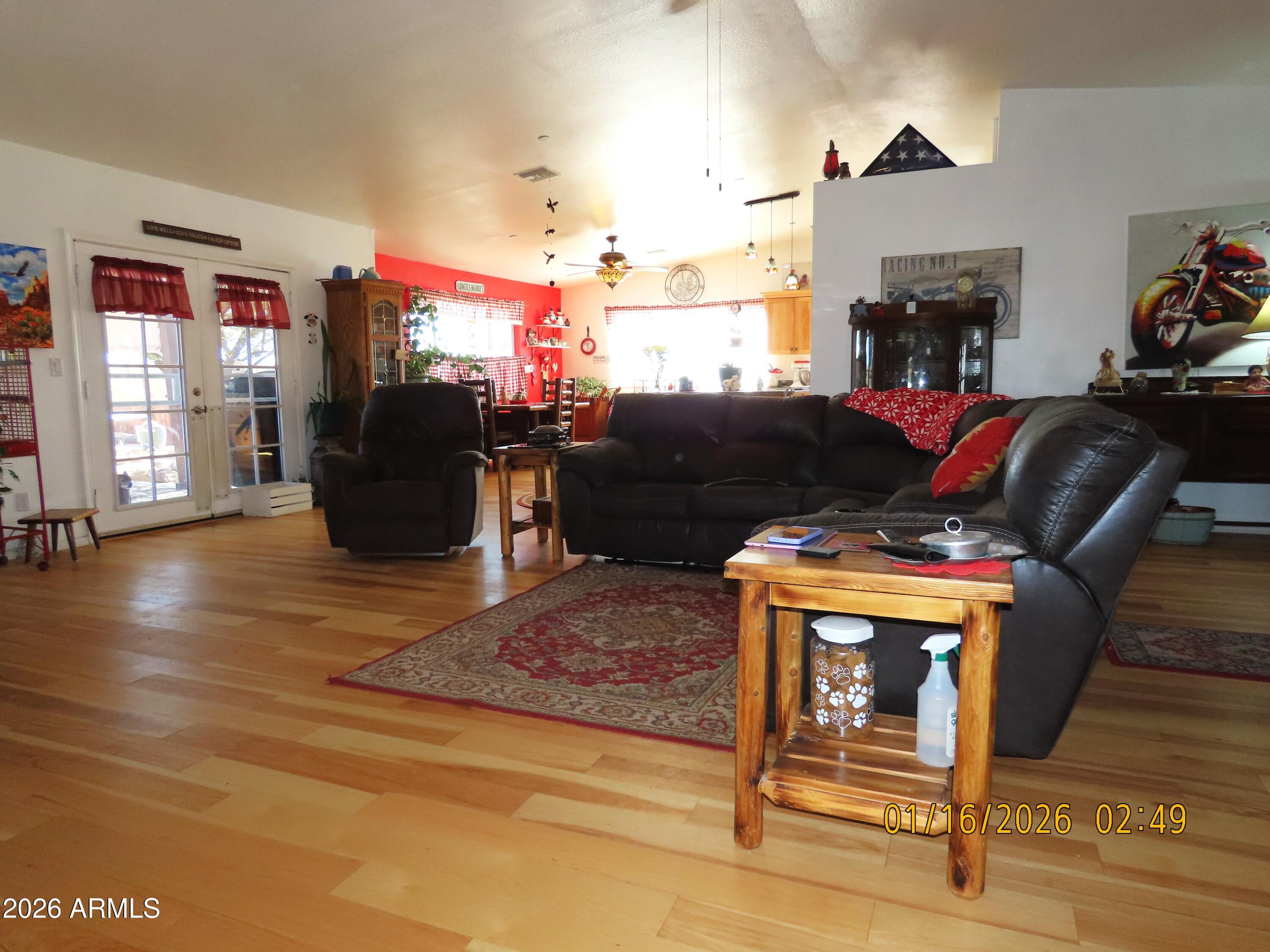 311 North Saddle Vista Road Benson, AZ 85602 - Photo 15 of 36 a living room with furniture a fireplace and a flat screen tv