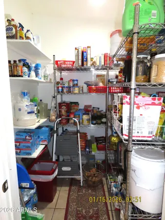 a room with stainless steel appliances kitchen island granite countertop a table and chairs