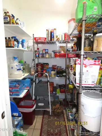 a room with stainless steel appliances kitchen island granite countertop a table and chairs