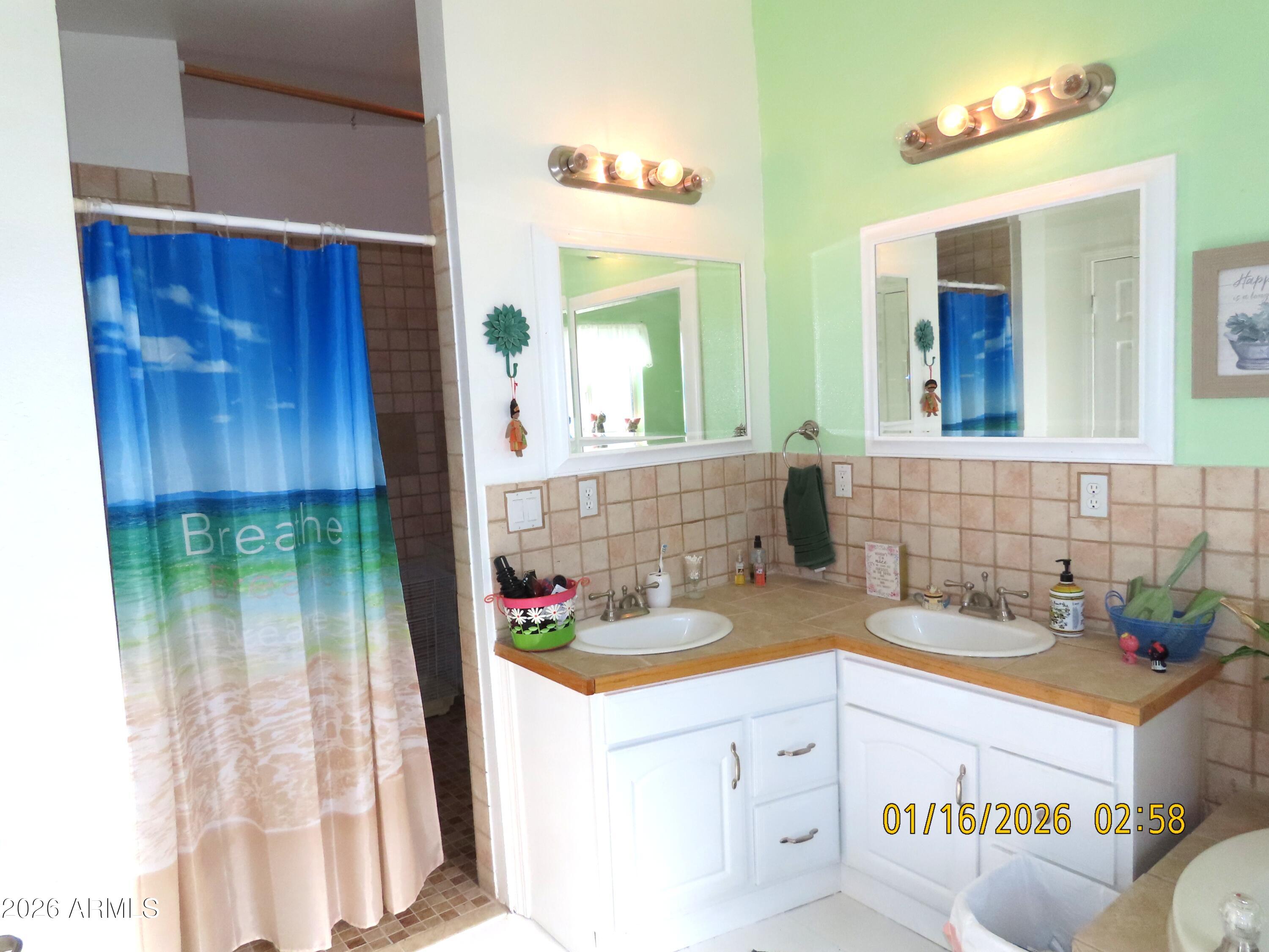 311 North Saddle Vista Road Benson, AZ 85602 - Photo 26 of 36 a bathroom with a sink and a mirror