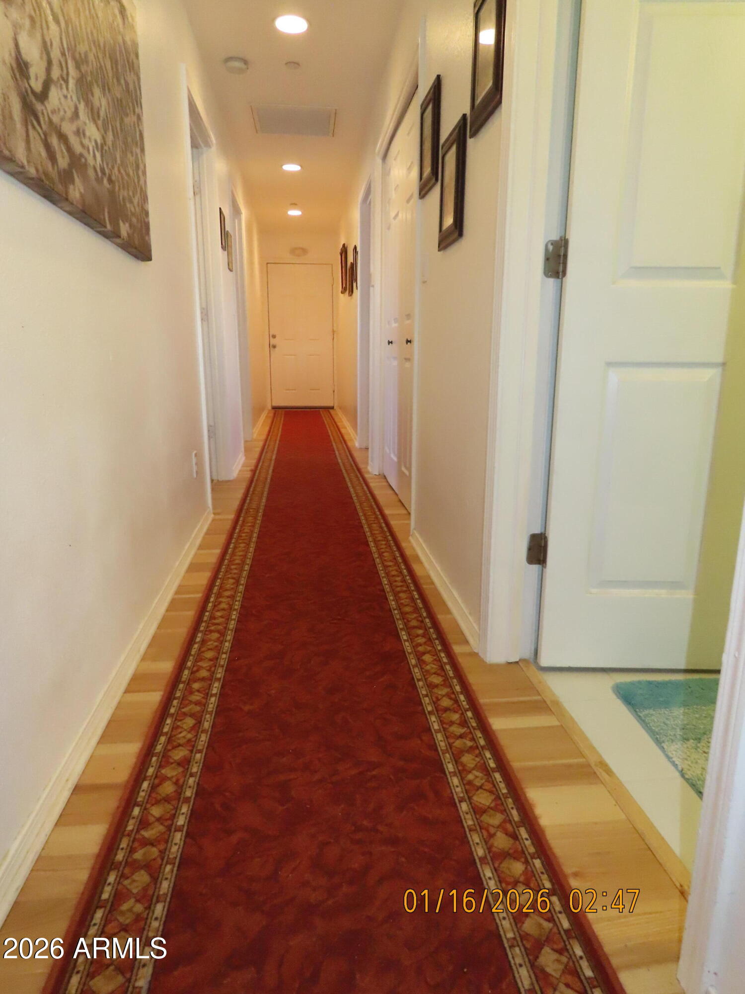 311 North Saddle Vista Road Benson, AZ 85602 - Photo 36 of 36 a view of a hallway with wooden floor and a carpet