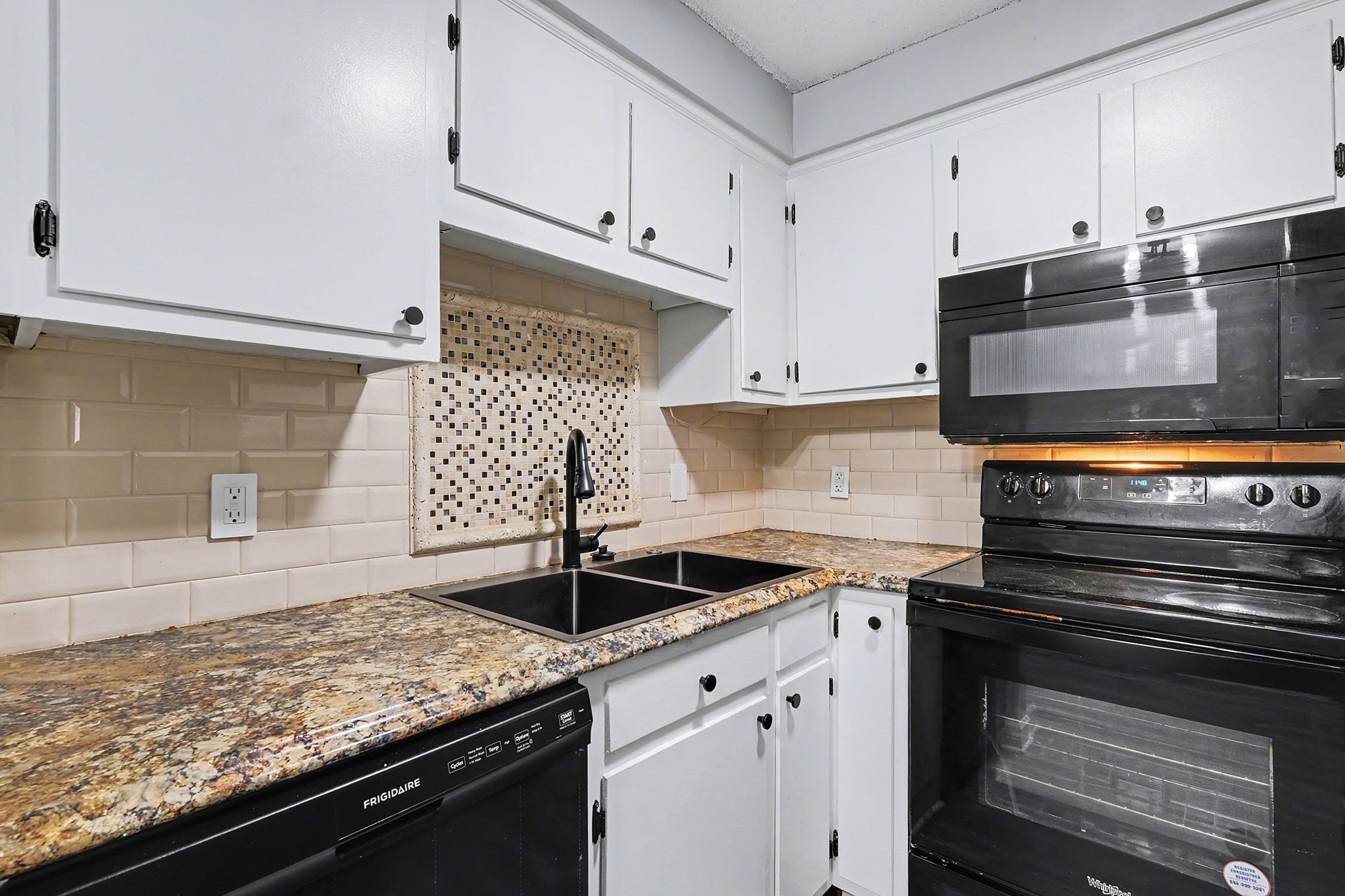 500 Paragon Mills Road, Unit N13 Nashville, TN 37211 - Photo 3 of 12 a kitchen with granite countertop stainless steel appliances and white cabinets