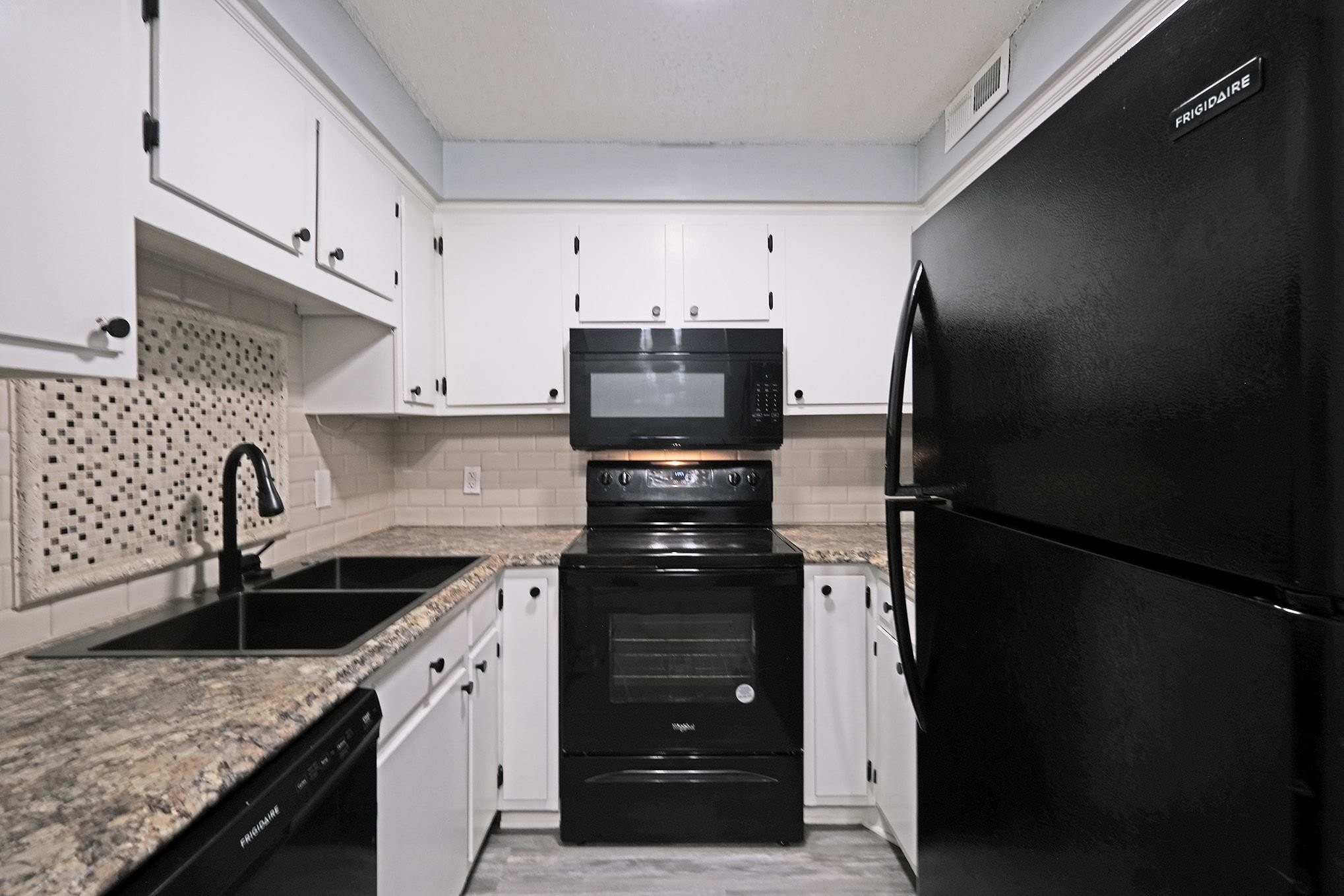 500 Paragon Mills Road, Unit N13 Nashville, TN 37211 - Photo 4 of 12 a kitchen with stainless steel appliances granite countertop a refrigerator and a sink