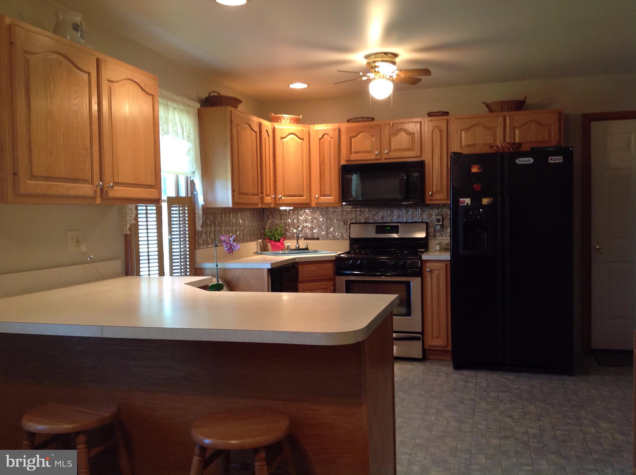 255 Ebenezer Road Halifax, PA 17032 - Photo 17 of 63 a kitchen with kitchen island a sink appliances and cabinets