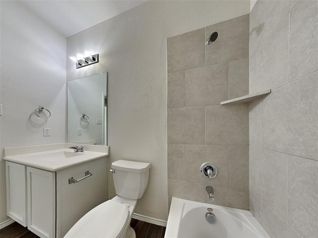506 Robinson Way Fate, TX 75189 - Photo 21 of 30 Bathroom with a textured wall, bathing tub / shower combination, and vanity