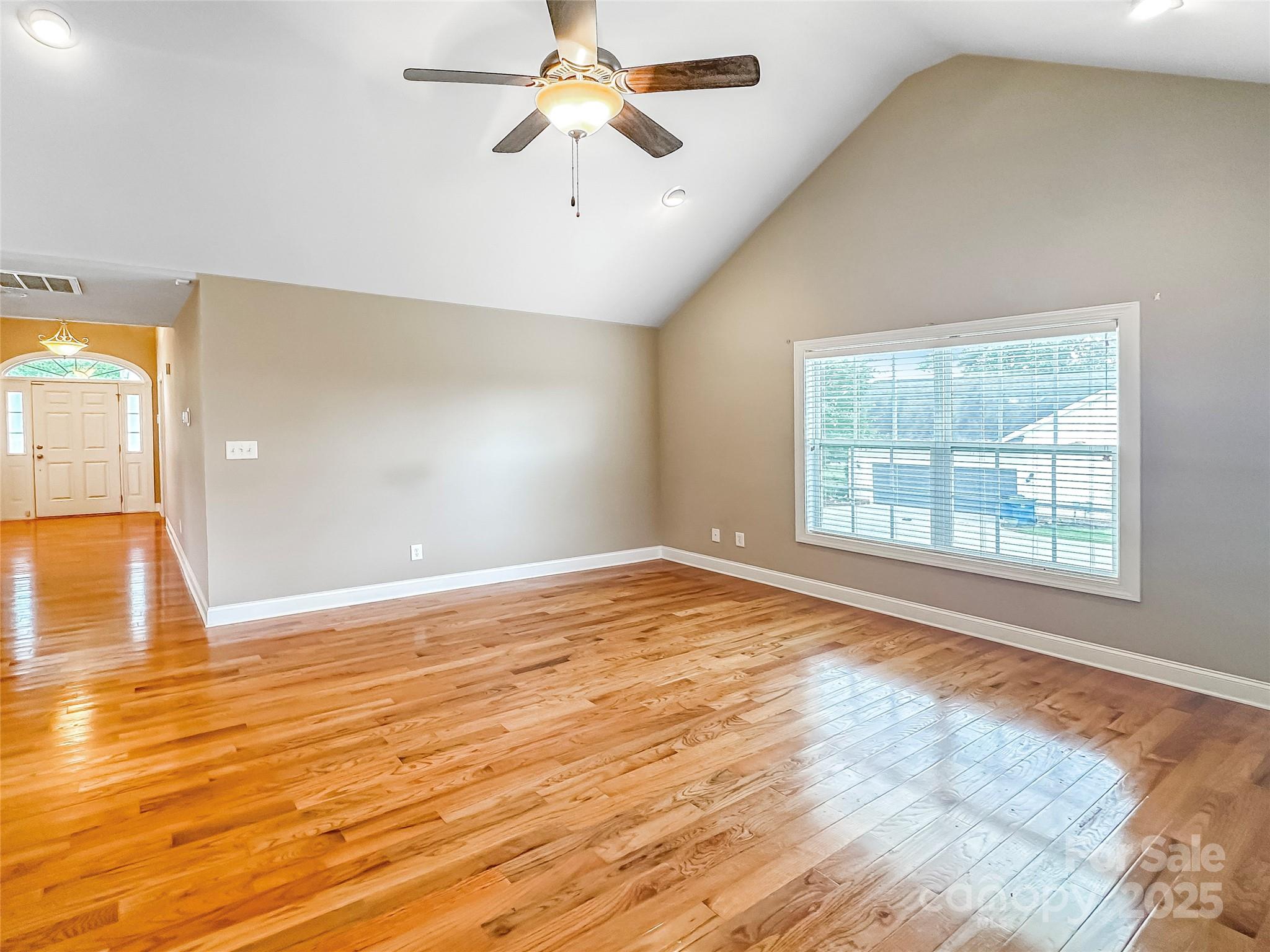 1625 Damascus Circle Conover, NC 28613 - Photo 12 of 40 an empty room with wooden floor fan and windows