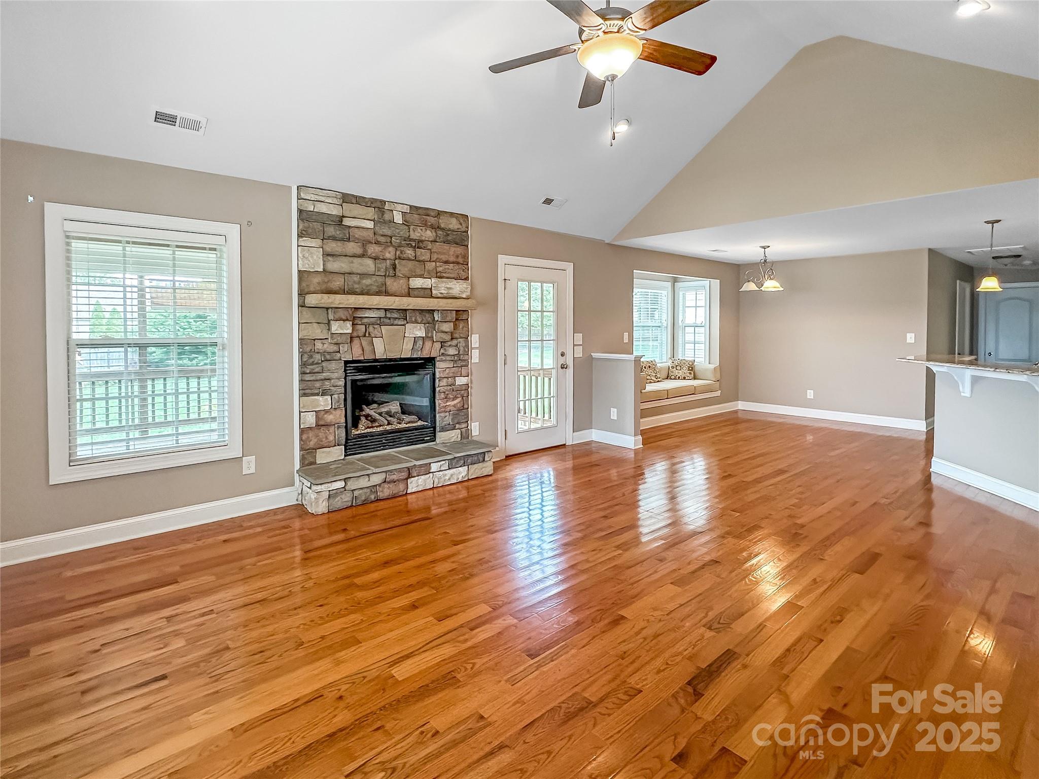 1625 Damascus Circle Conover, NC 28613 - Photo 14 of 40 an empty room with wooden floor fireplace and windows