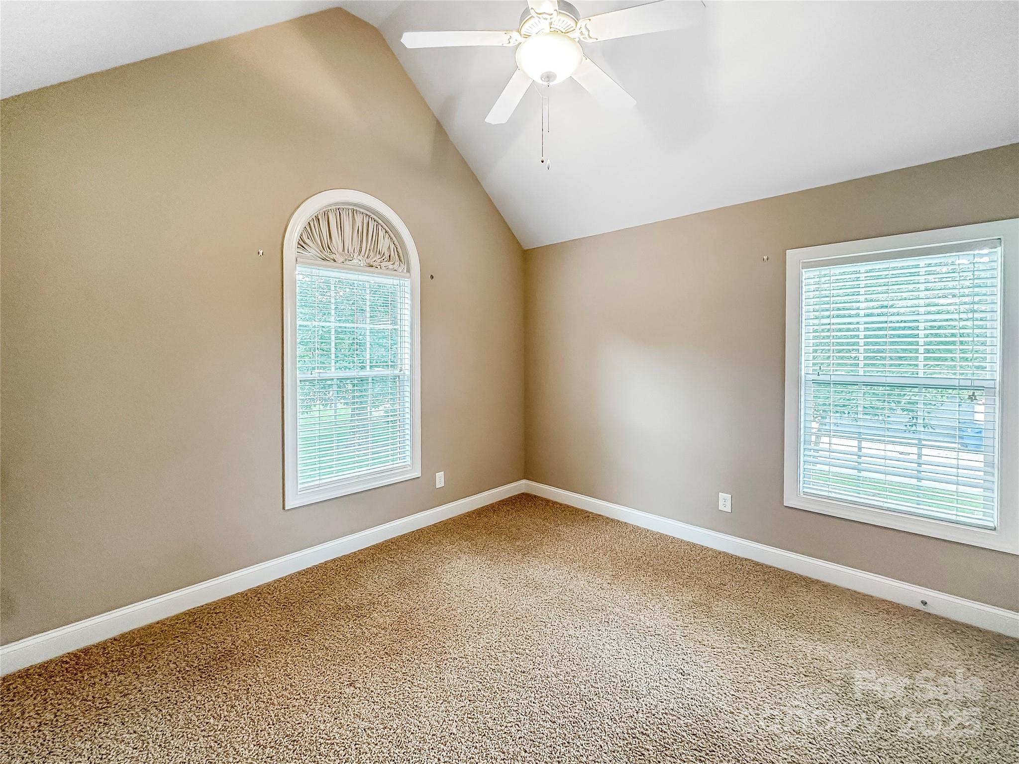1625 Damascus Circle Conover, NC 28613 - Photo 24 of 40 an empty room with windows and chandelier fan
