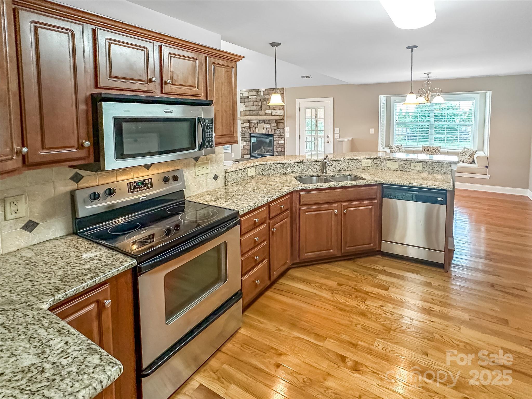 1625 Damascus Circle Conover, NC 28613 - Photo 4 of 40 a kitchen with stainless steel appliances granite countertop a stove microwave and sink