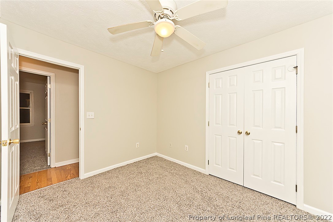 406 Kernstown Road Raeford, NC 28376 - Photo 13 of 22 an empty room with closet and a chandelier fan