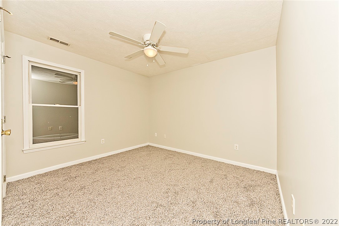 406 Kernstown Road Raeford, NC 28376 - Photo 14 of 22 an empty room with a window and ceiling fan