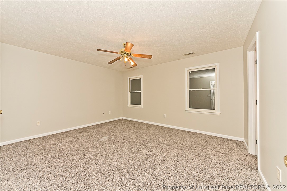 406 Kernstown Road Raeford, NC 28376 - Photo 17 of 22 an empty room with a empty space and windows