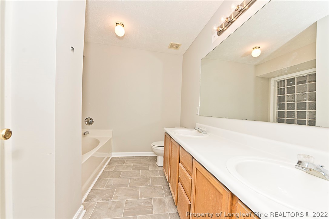 406 Kernstown Road Raeford, NC 28376 - Photo 20 of 22 a bathroom with a tub sink and a mirror