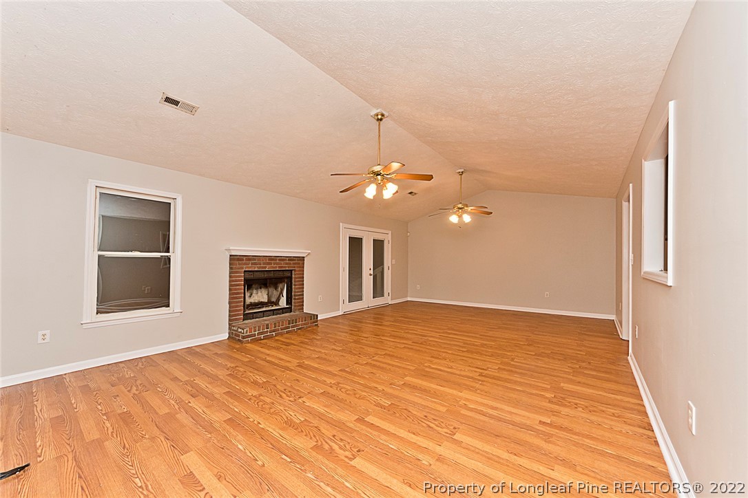 406 Kernstown Road Raeford, NC 28376 - Photo 4 of 22 a view of an empty room with a window and fireplace