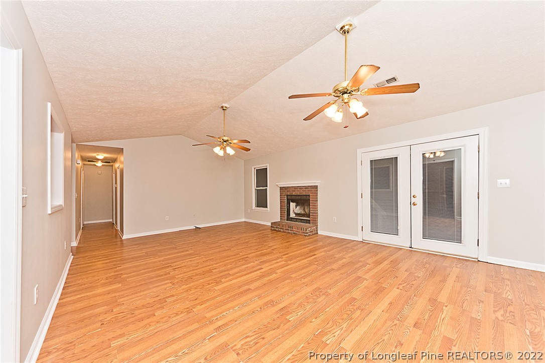 406 Kernstown Road Raeford, NC 28376 - Photo 5 of 22 a view of an empty room with chandelier fan and a fireplace