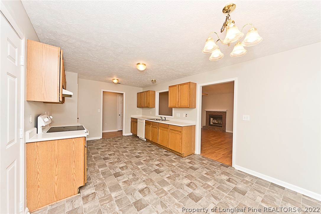 406 Kernstown Road Raeford, NC 28376 - Photo 8 of 22 a kitchen with stainless steel appliances a refrigerator and a stove top oven