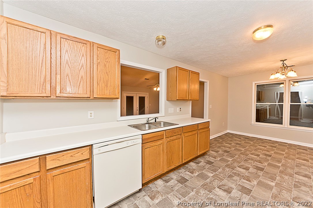 406 Kernstown Road Raeford, NC 28376 - Photo 10 of 22 a kitchen with stainless steel appliances granite countertop a sink and a stove