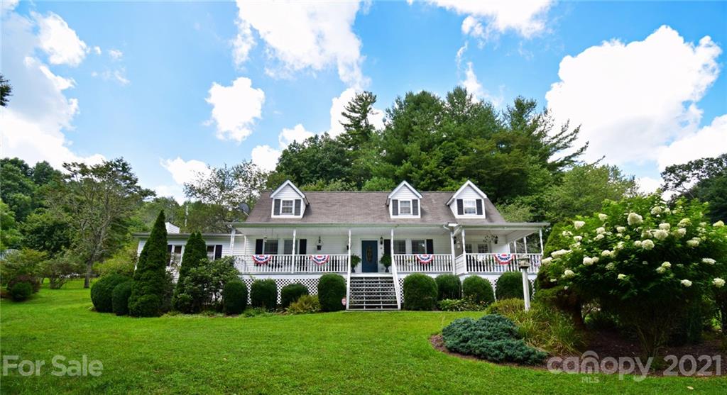 a front view of a house with a yard table and chairs