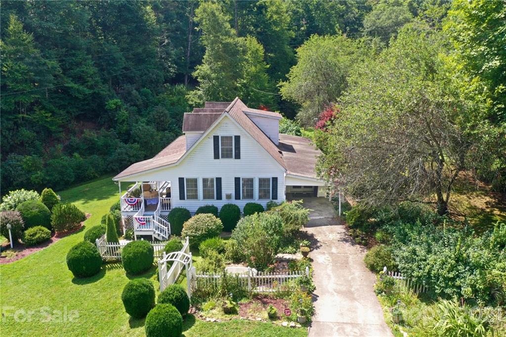 5424 Castle Ford Road Boone, NC 28607 - Photo 11 of 48 a front view of a house with a yard and potted plants
