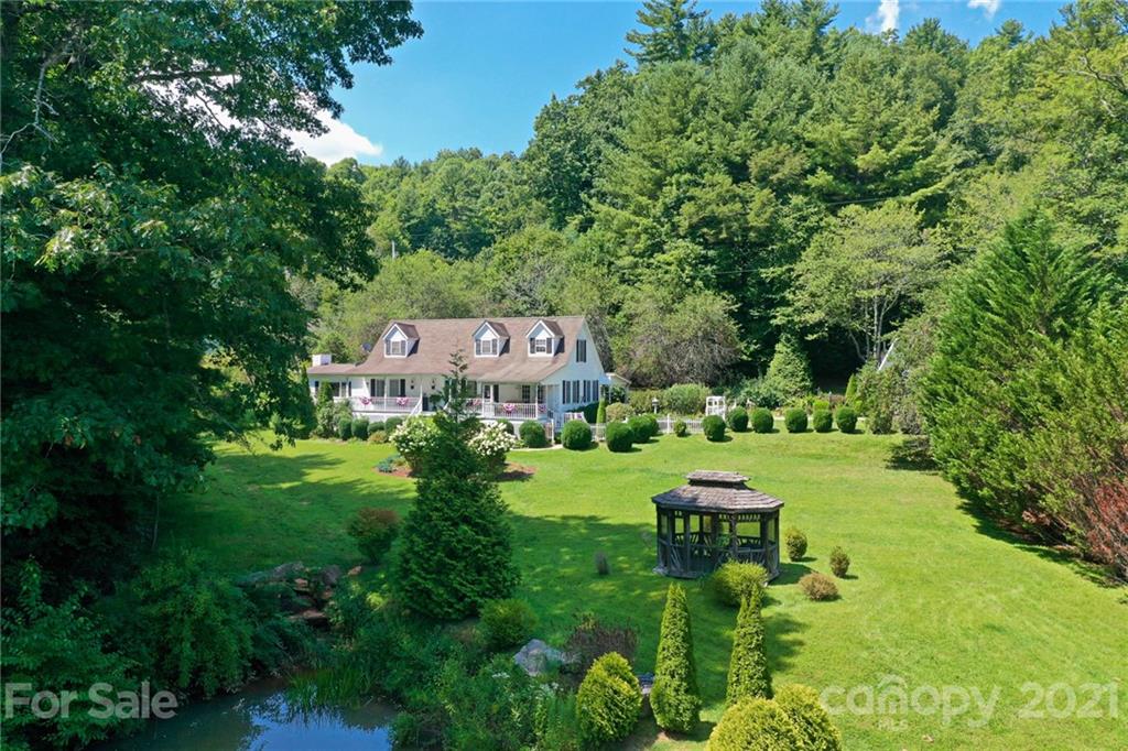 5424 Castle Ford Road Boone, NC 28607 - Photo 14 of 48 a view of a garden with plants and large trees