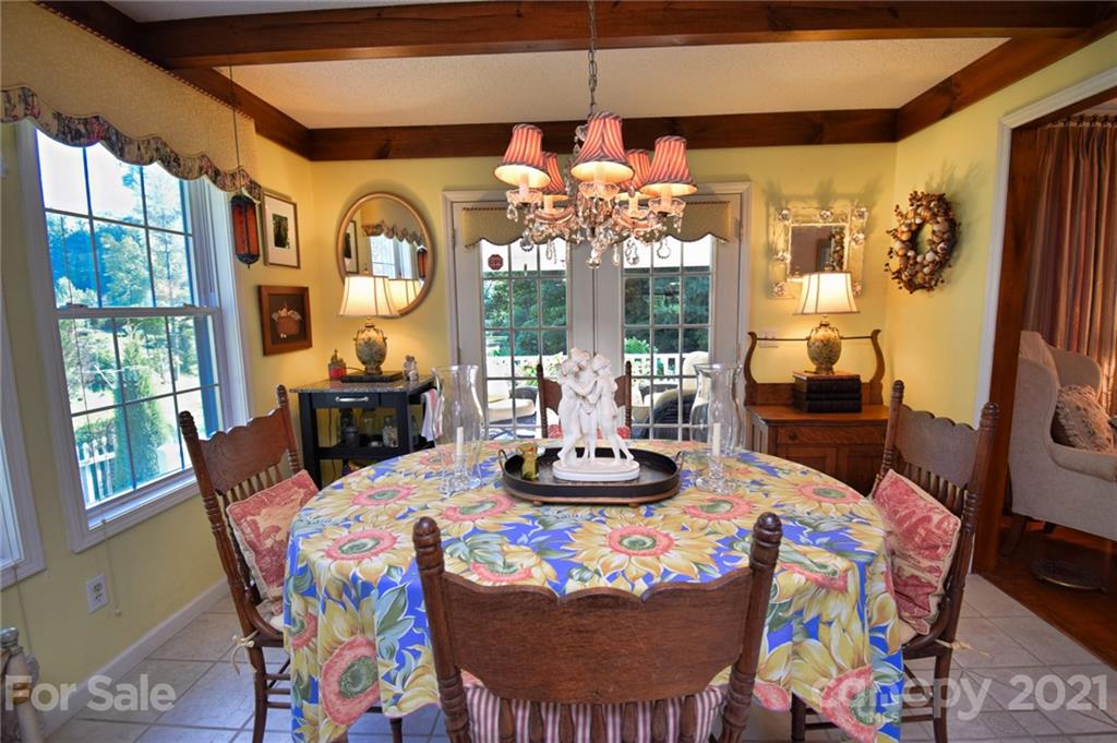 5424 Castle Ford Road Boone, NC 28607 - Photo 23 of 48 a view of a dining room with furniture a chandelier and large windows
