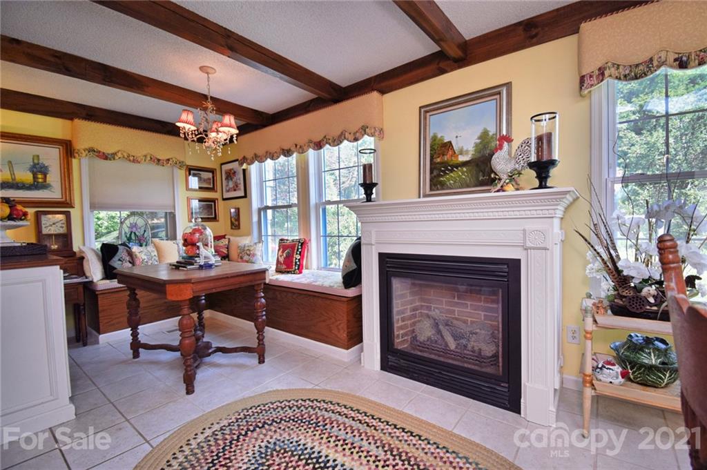 5424 Castle Ford Road Boone, NC 28607 - Photo 26 of 48 a living room with furniture a table and a fireplace