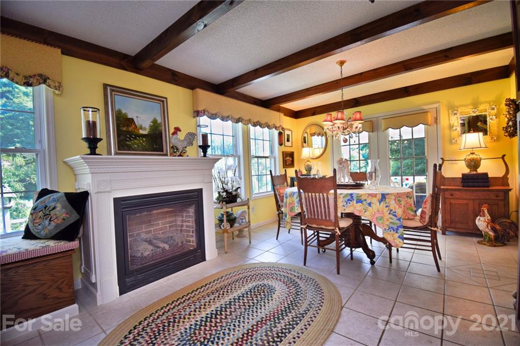 5424 Castle Ford Road Boone, NC 28607 - Photo 27 of 48 a living room with furniture a large window and a fireplace