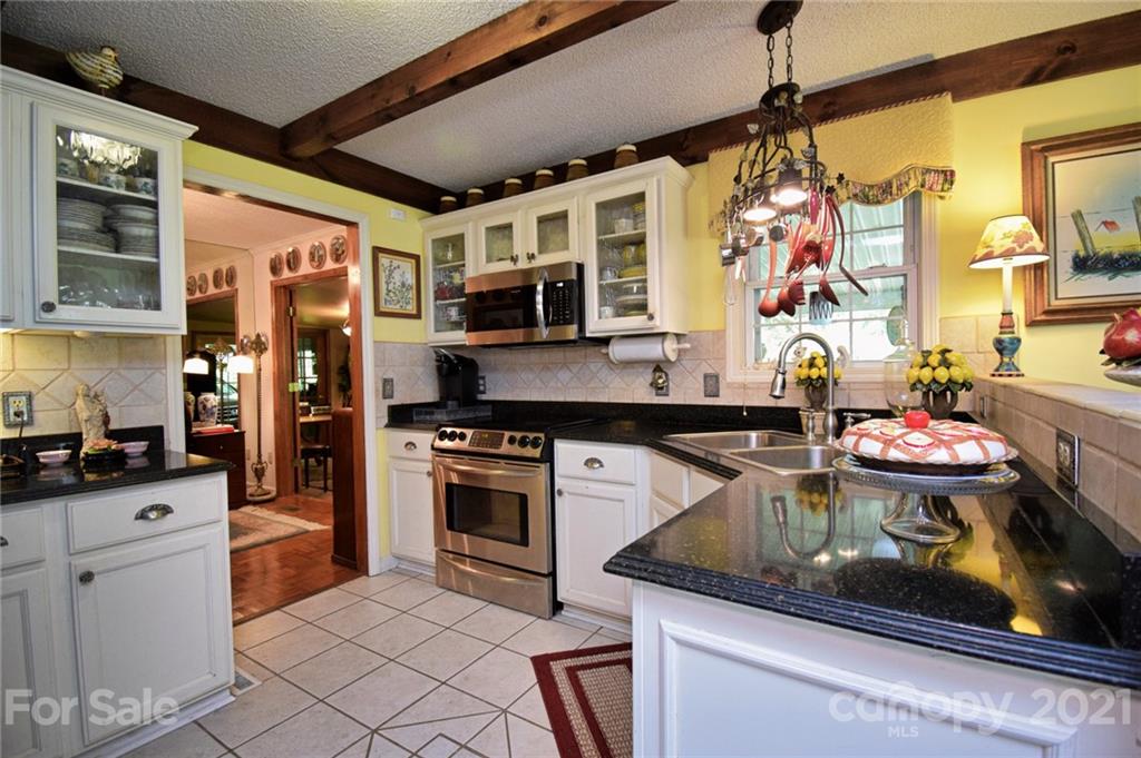 5424 Castle Ford Road Boone, NC 28607 - Photo 28 of 48 a kitchen with stainless steel appliances granite countertop a stove and a sink