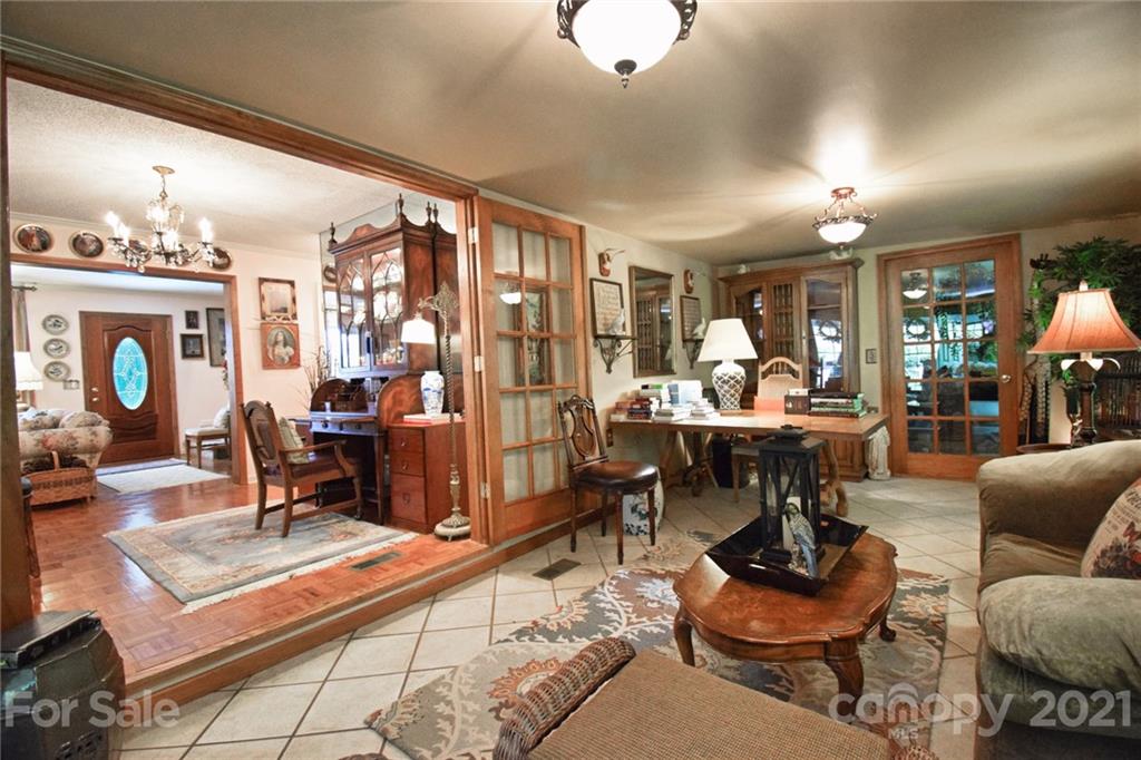 5424 Castle Ford Road Boone, NC 28607 - Photo 31 of 48 a living room with fireplace furniture and a chandelier