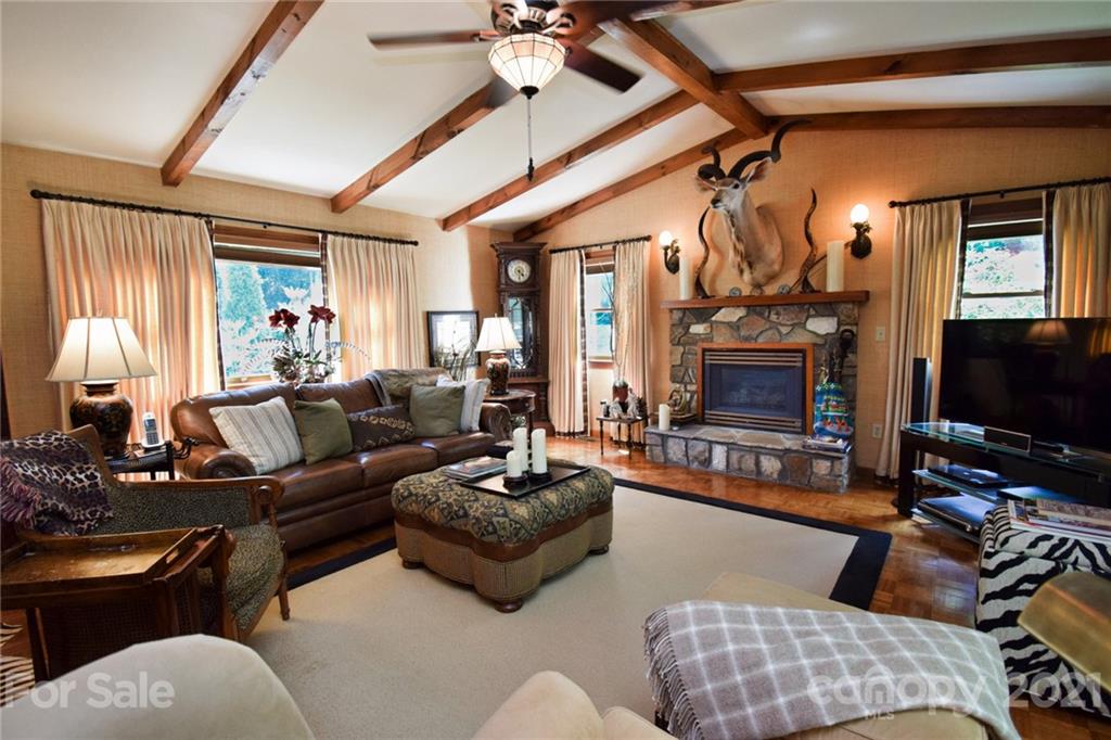 5424 Castle Ford Road Boone, NC 28607 - Photo 39 of 48 a living room with furniture a flat screen tv and a fireplace