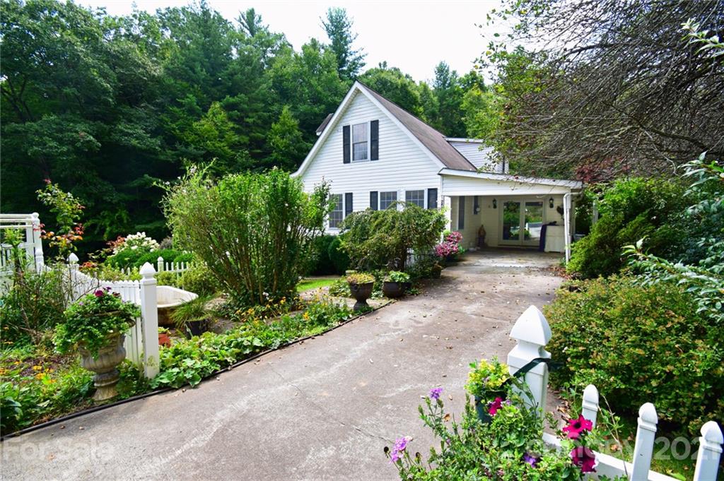 5424 Castle Ford Road Boone, NC 28607 - Photo 5 of 48 a front view of a house with a yard and potted plants