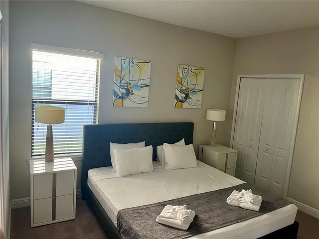 a bed sitting in a bedroom next to a window