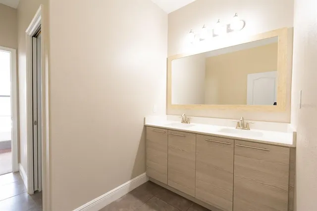 a bathroom with a double vanity sink and mirror
