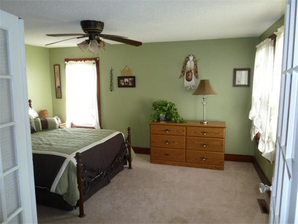 123 Lawrence Road Chicopee, MA 01013 - Photo 13 of 23 a bedroom with a bed and a chandelier