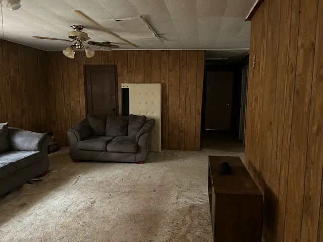 a living room with furniture and a chandelier