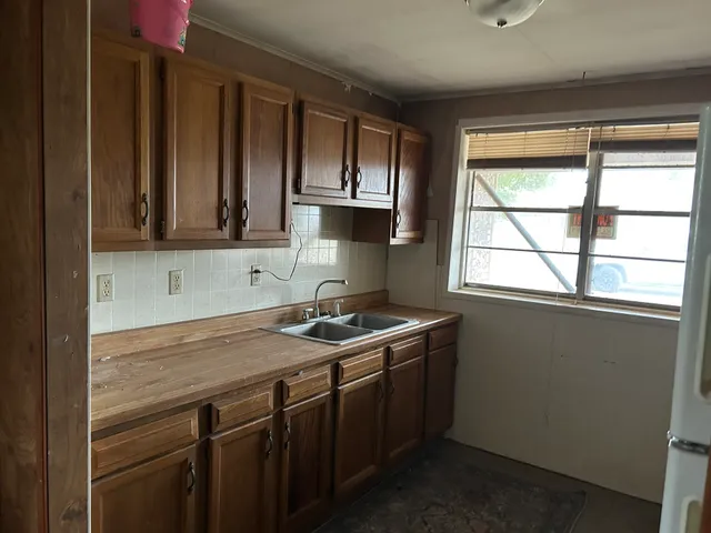 a kitchen with a sink cabinets and window