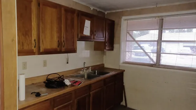a kitchen with a sink and cabinets