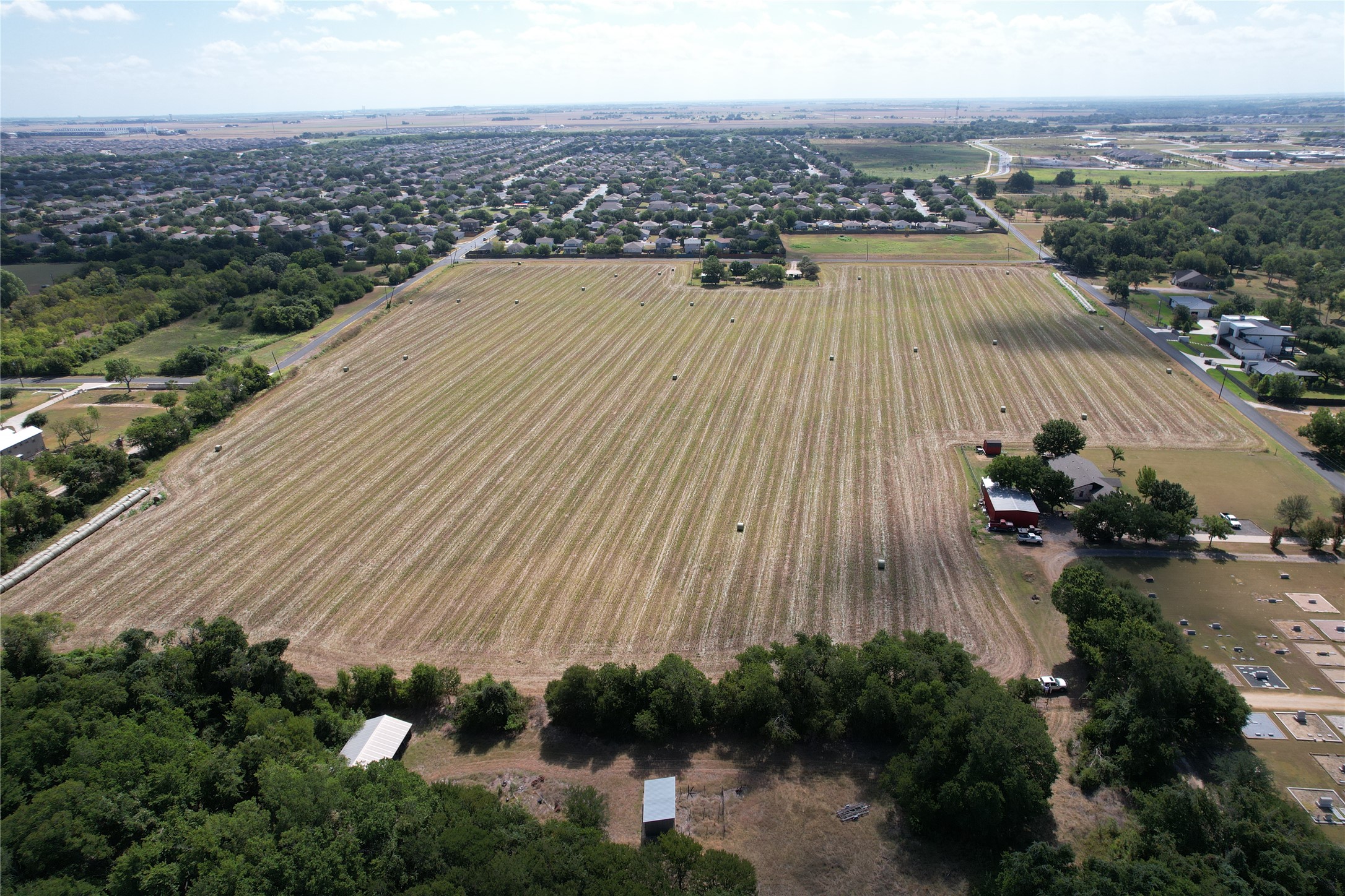 135 Rd Hutto Tx 78634 Road Hutto, TX 78634 - Photo 9 of 10 An expansive agricultural tract offers vast open acreage bordered by mature native trees.