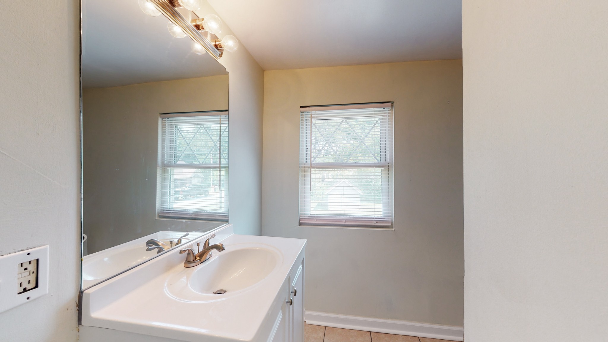 343 Neelys Bend Road Madison, TN 37115 - Photo 23 of 28 a bathroom with a sink vanity and a mirror
