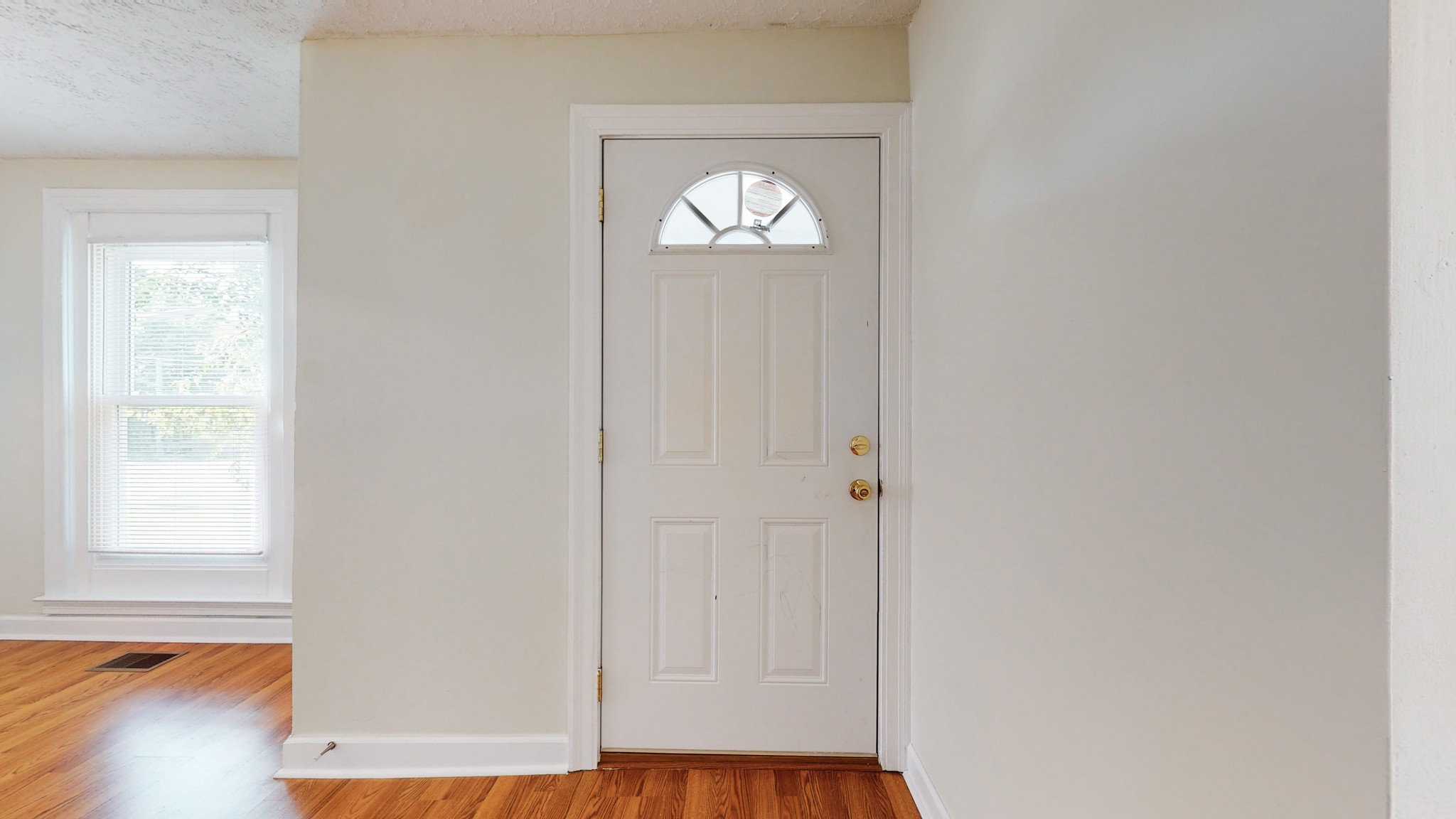 343 Neelys Bend Road Madison, TN 37115 - Photo 4 of 28 a view of an empty room with wooden floor and a window